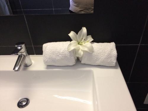 a white towel sitting on top of a white sink at KR Hotels - Albufeira Lounge in Albufeira