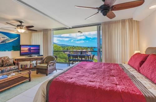 a bedroom with a large bed and a large window at Mana Kai 611C in Wailea