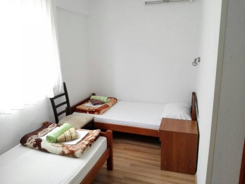a room with two beds and a table in it at Sobe BCRNJAC in Međugorje
