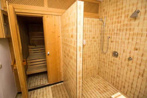 a bathroom with a shower and a walk in shower at Hotel Altwirt in Lenggries