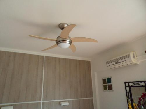 a ceiling fan in a living room with at Rea Hotel in Faliraki