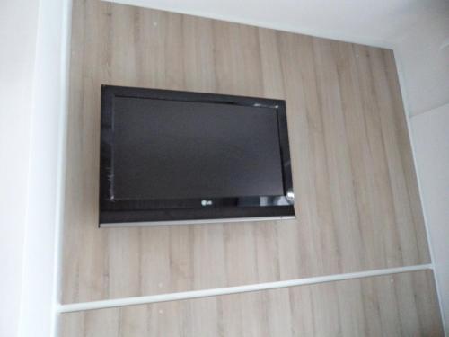 a flat screen tv hanging on a wall at Rea Hotel in Faliraki