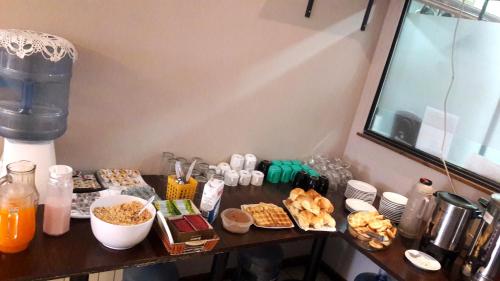 a table with some food and drinks on it at Hotel Antartida Argentina in Ushuaia