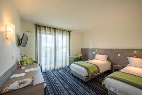 Postel nebo postele na pokoji v ubytování Hotel Le Chatard
