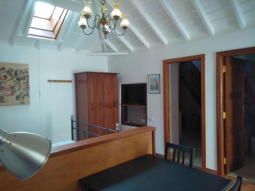 a dining room with a table and a chandelier at Casa Elvira in Santa Cruz de la Palma