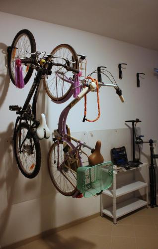 two bikes are hanging on a wall at Apartment Villa Franci in Pag
