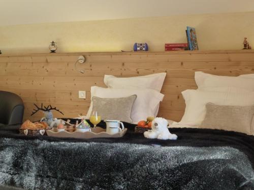 a tray with food and drinks on a bed at Hôtel Restaurant "Les Sapins" Wellness & Gourmet in Manigod