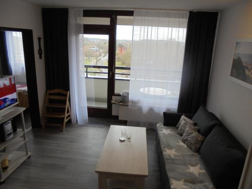 a living room with a couch and a coffee table at Ostseemuschel in Damp