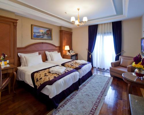 a hotel room with a large bed and a couch at GLK PREMIER Acropol Suites & Spa in Istanbul