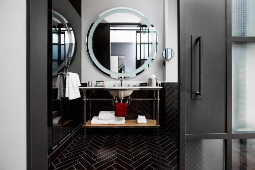 a bathroom with a sink and a mirror at Bobby Hotel in Nashville