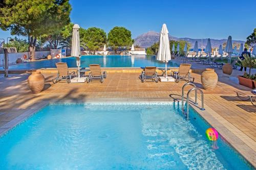 a pool with chairs and a ball in the water at Airotel Achaia Beach in Patra