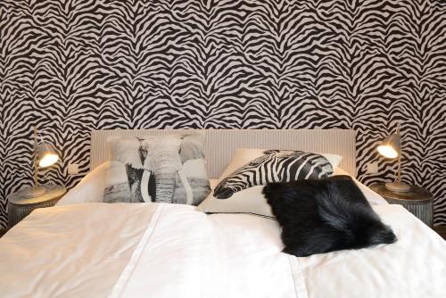 a bedroom with a bed with a zebra and elephants at Vinotel Dollt-Kern in Flemlingen