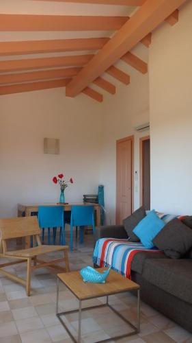 a living room with a couch and a table at Résidence les Hameaux de Bocca del Oro in Porto-Vecchio
