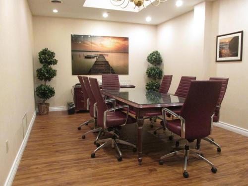 a conference room with a table and chairs at The Fredericton Inn in Fredericton