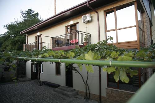 a building with two balconies on the side of it at Luxury Villa Nieli in Tbilisi City