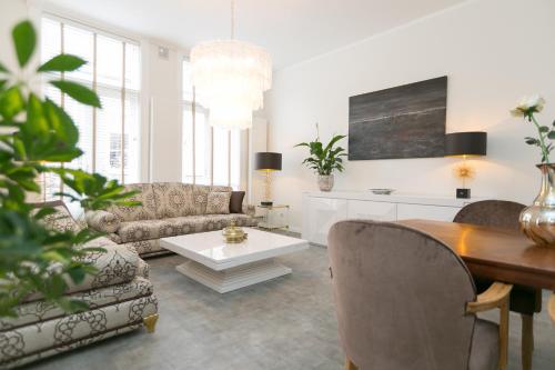 a living room with a couch and a table at The City Palace - R.Q.C. in The Hague