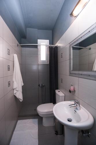 a bathroom with a sink and a toilet and a mirror at Luxury Villa Melissa in Ferma