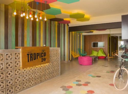 a room with a colorful room with a bike in it at Hostel Frente al Mar Tropico 20º in Cozumel