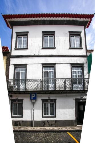 a white building with a balcony on top of it at Hotel São Miguel in Ponta Delgada
