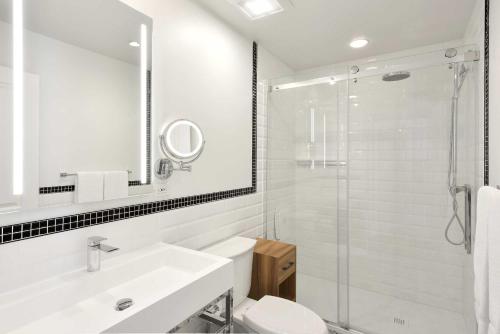 a bathroom with a toilet and a sink and a shower at Hotel Bonaparte in Montréal