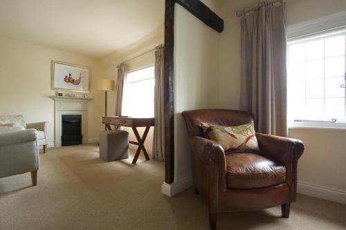 
a living room filled with furniture and a window at The Royal Oak, Yattendon in Frilsham
