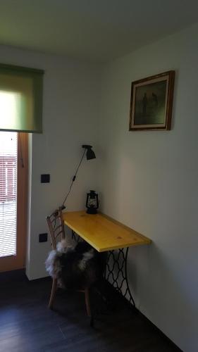 a table in a room with a lamp and a chair at Guesthouse S in Luče