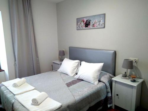 a bedroom with a bed with two towels on it at La Quintana de Ribadesella in Ribadesella