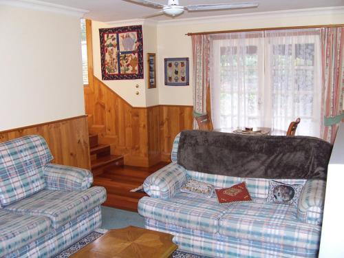 a living room with a couch and a chair at Donalea Bed and Breakfast & Riverview Apartment in Castle Forbes Bay