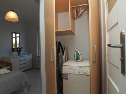 a small kitchen with a stove and a refrigerator at Grand Tourist Gemini in Gdańsk