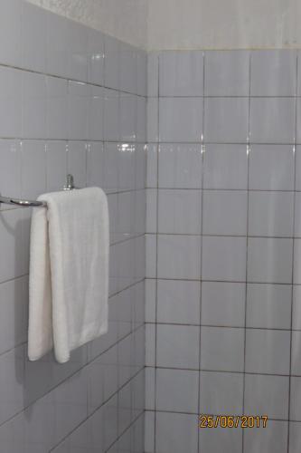 un asciugamano bianco appeso a un portasciugamani in bagno di Hotel Agbeviade a Palimé