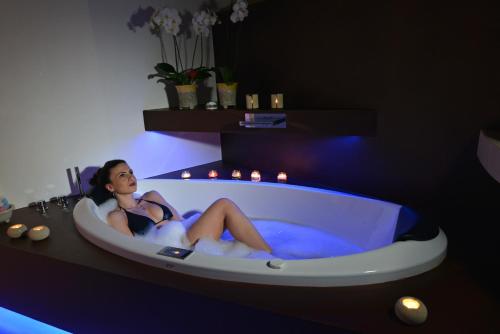 a woman is sitting in a bath tub at Antica Torre di Iuso in Matera