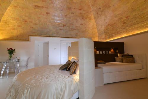 a bedroom with a large bed and a couch at Antica Torre di Iuso in Matera