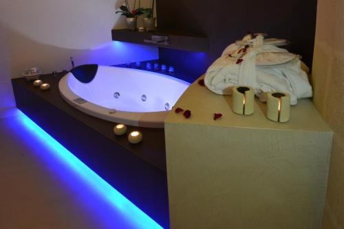 a bathroom with a bath tub with purple lights at Antica Torre di Iuso in Matera