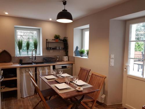 a kitchen with a table and chairs and a kitchen with windows at Bastide en Provence in Auriol