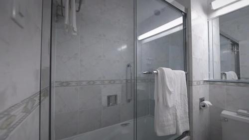 a bathroom with a shower with a glass door at Congress Plaza Hotel Chicago in Chicago