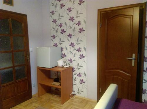 een kamer met een deur en een koelkast aan de muur bij Pokoje u Jolanty in Władysławowo