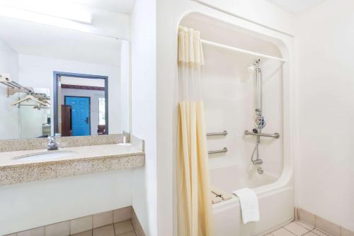 a bathroom with a shower and a sink at Days Inn by Wyndham Blythewood North Columbia in Blythewood