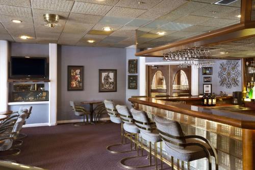 a bar in a restaurant with chairs and a counter at Days Inn by Wyndham Lawton in Lawton