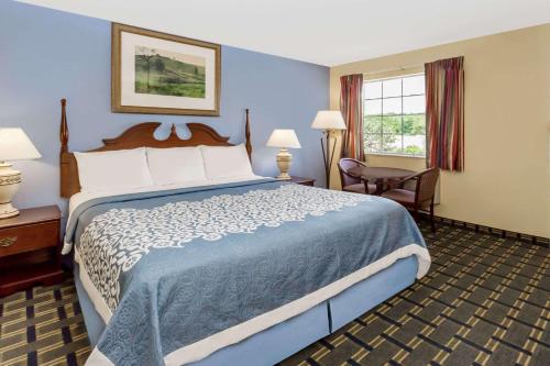 a hotel room with a large bed and a window at Days Inn by Wyndham Plymouth in Plymouth