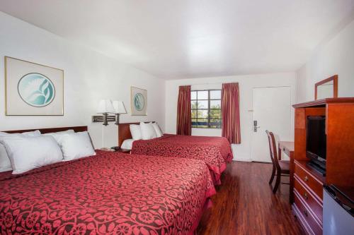 Habitación de hotel con 2 camas y TV en Days Inn by Wyndham Orange Anaheim, en Orange
