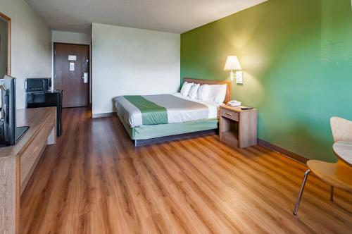 a hotel room with a bed and a television at Motel 6-Drums in Drums