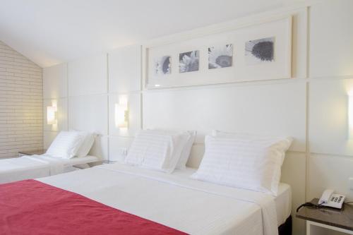 Cama o camas de una habitación en el Hotel Confiance Soho Batel