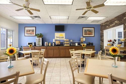 a restaurant with tables and chairs and a waiting room at Days Inn by Wyndham Oglesby/ Starved Rock in Oglesby