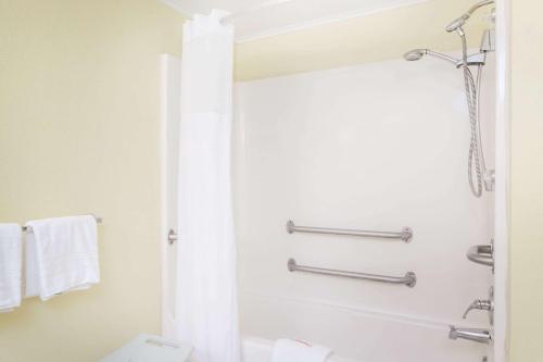 a bathroom with a shower and a toilet at Days Inn by Wyndham Dover Downtown in Dover