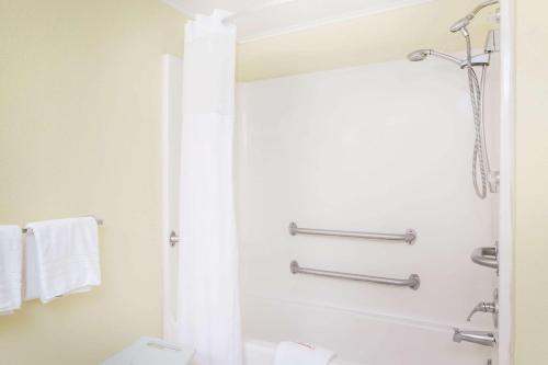 uma casa de banho com um chuveiro e um WC. em Days Inn by Wyndham Dover Downtown em Dover