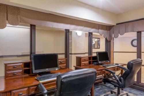 an office with two desks with two computers on them at Days Inn & Suites by Wyndham Bridgeport - Clarksburg in Bridgeport