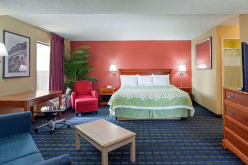 a hotel room with a bed and a desk at Shelby Inn in Memphis