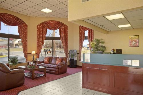 a waiting room with couches and a cash register at Days Inn by Wyndham Apple Valley Pigeon Forge/Sevierville in Pigeon Forge