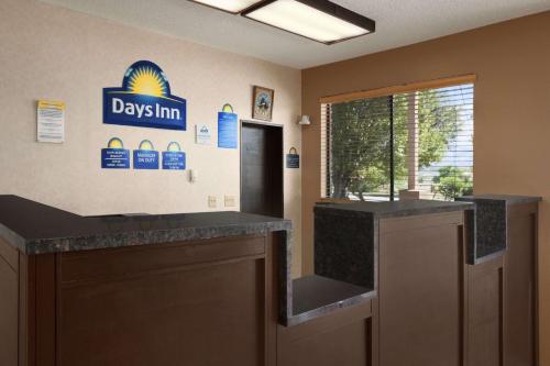 a lobby with a day inn sign on the wall at Days Inn by Wyndham Cortez in Cortez