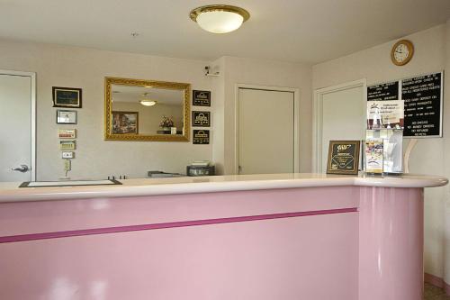 a pink counter in a restaurant with a mirror at Days Inn by Wyndham Hayward Airport in Hayward